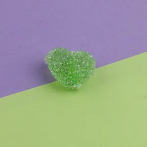 Close-up of green acrylic heart sugar bead with sparkling crystal texture for DIY jewelry.