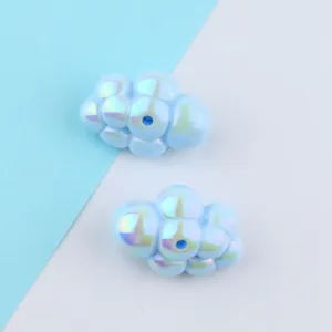 Closeup of iridescent acrylic cloud beads with vertical holes for DIY jewelry making.