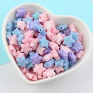 Close-up view of sparkling glitter star beads for DIY crafts and jewelry accessories.