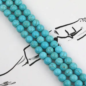 Close-up detail of blue turquoise round beads string, showing natural matrix texture and fine polish.