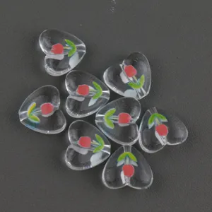 Close up of clear acrylic heart beads with cute tulip print, detailed diy craft material.