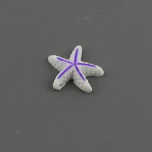 Resin starfish charm detail, white and purple DIY craft cabochon for hair clip decoration.