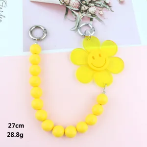 Yellow beaded strap with acrylic smiley flower pendant, perfect phone charm and bag chain.