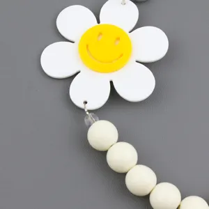 Detailed close-up of the acrylic smiley sun flower pendant with beaded chain design.