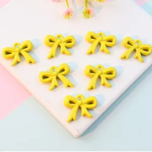 Cute yellow acrylic bow pendants with hanging hole solid color ribbon charms for DIY jewelry making crafts