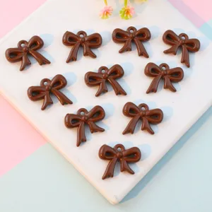 Brown acrylic bow pendants with holes for DIY jewelry making, cute hollow bow charms accessory.