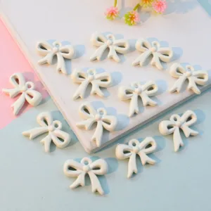 White ribbon bowknot pendant charms with hanging hole, hollow DIY jewelry accessories for crafting.