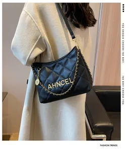 Black quilted underarm bag with gold chain strap, stylish shoulder bag for women daily wear.