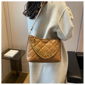 Detailed shot of a stylish brown quilted underarm shoulder bag with luxury chain strap.