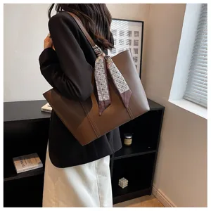 Stylish women's brown PU leather tote bag with elegant scarf, versatile shoulder commuting bag.