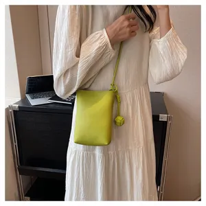 Minimalist lime green mini crossbody phone bag for women, stylish casual shoulder bag.
