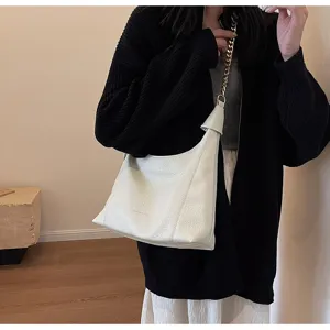 Elegant white leather hobo shoulder bag with chic chain strap and vintage lychee pattern.