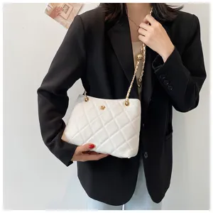 Detail view of white quilted shoulder bag with gold chain strap, stylish women's fashion handbag.