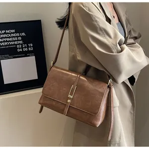 Elegant retro brown leather shoulder bag for women, chic crossbody bag with metal lock.