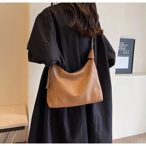Detail view of a vintage brown litchi grain shoulder bag, elegant everyday commuter style.