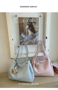 Stylish summer tote shoulder bag for women, large capacity casual commuting handbag with charm.