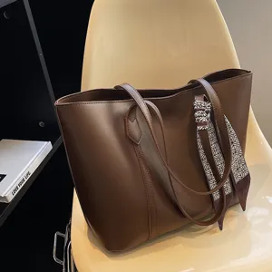 Stylish brown leather tote bag for women, perfect commuter shoulder bag for daily casual use.