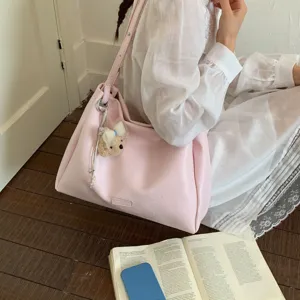 Stylish pink tote shoulder bag for women, large capacity casual daily commuting handbag.