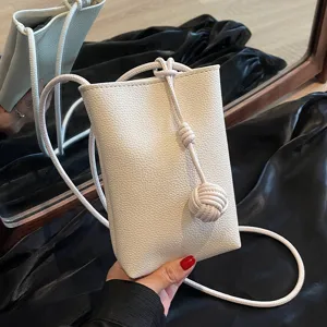 Minimalist white leather mini crossbody phone bag with chic strap knot design for women style.