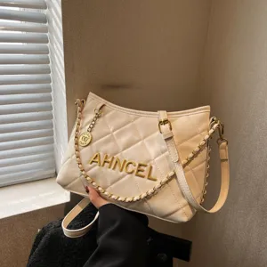 White quilted leather shoulder bag with gold chain strap and stylish metallic lettering main view.