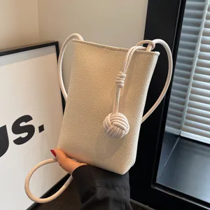 Mini white leather crossbody phone bag for women, stylish casual shoulder bag with knot strap.