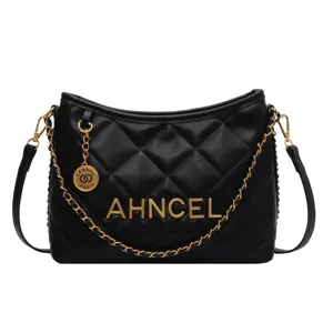 Black quilted leather shoulder bag featuring stylish gold chain strap and metallic letters.