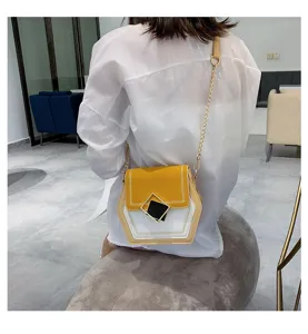 Detail shot of the stylish hexagonal color-blocked cross-body bag with chain strap and square buckle.
