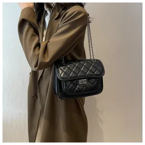 Classic black quilted shoulder bag detail, elegant chain strap and metal turn-lock design.