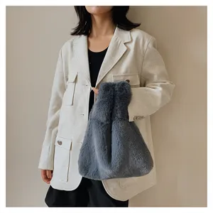 Plush fuzzy handbag detail view showing soft grey faux fur texture and comfortable hand grip design.