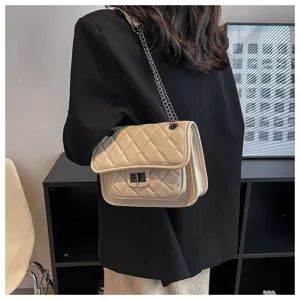 Detailed view of women's beige quilted shoulder bag with chain strap and elegant twist lock.