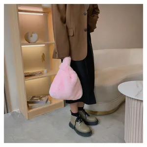 Chic pink plush knot handbag detail, soft fuzzy wrist bag for women fashion style, trendy daily use.