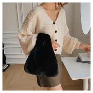 Stylish black faux fur handbag for women, soft plush tote bag for daily fashion wear.