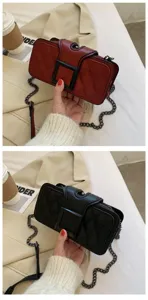 Detailed view of fashionable quilted crossbody shoulder bag with bold square buckle and metal chain.