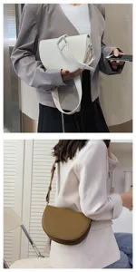 Minimalist half-moon saddle bag with wide shoulder strap for women, stylish everyday wear.