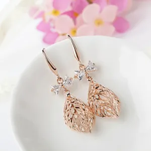 Rose gold plated filigree leaf drop earrings with sparkling crystal bows. Elegant women jewelry