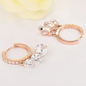Detail view of stylish rose gold hoop earrings featuring sparkling zircon stone drops, chic.