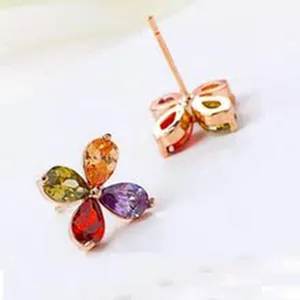 Multi-color cubic zirconia flower stud earrings in rose gold finish, elegant jewelry detail shot.