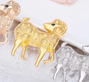 Close-up detail of the metal zodiac sheep brooch showcasing shiny metallic finish.