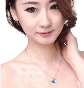Detailed close-up view of the sparkling crystal fish pendant necklace worn gracefully by model.