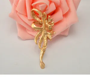 Gold-tone alloy rhinestone vintage bow brooch pin back view detail fashion jewelry accessory.