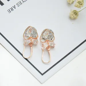 Charming rose gold heart zircon earrings with delicate bow details, exquisite detail shot.