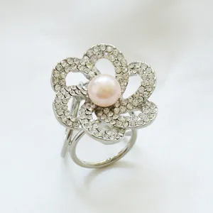 Elegant rhinestone flower scarf ring with pearl center, sparkling fashion accessory.