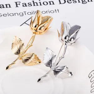 Elegant metallic rose flower brooch in gold and silver, perfect suit and coat accessory.