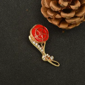 Broche de clavel dorado con esmalte rojo y pedrería brillante para regalo elegante.