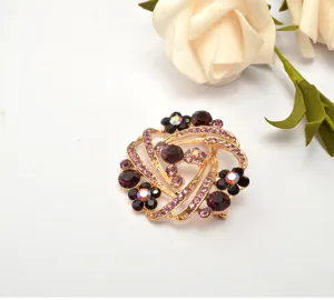 Elegant rhinestone flower brooch pin, gold-toned metal with purple crystal details for women.