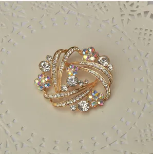Elegant gold-tone crystal rhinestone swirl brooch pin fashion women jewelry accessory.