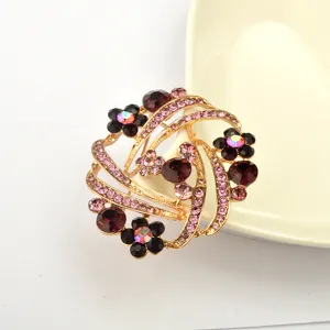Elegant rhinestone flower brooch in gold tone, sparkling crystal pin for women fashion accessory.
