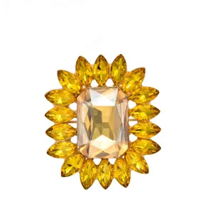 Crystal rhinestone flower brooch, elegant gold-tone metal, sparkling fashion jewelry.