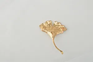 Gold ginkgo leaf brooch pin, detailed back view showing secure clasp and metal crafting.