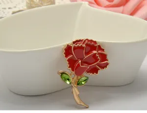 Detailed view of red carnation brooch with green crystal leaves and zinc alloy body.